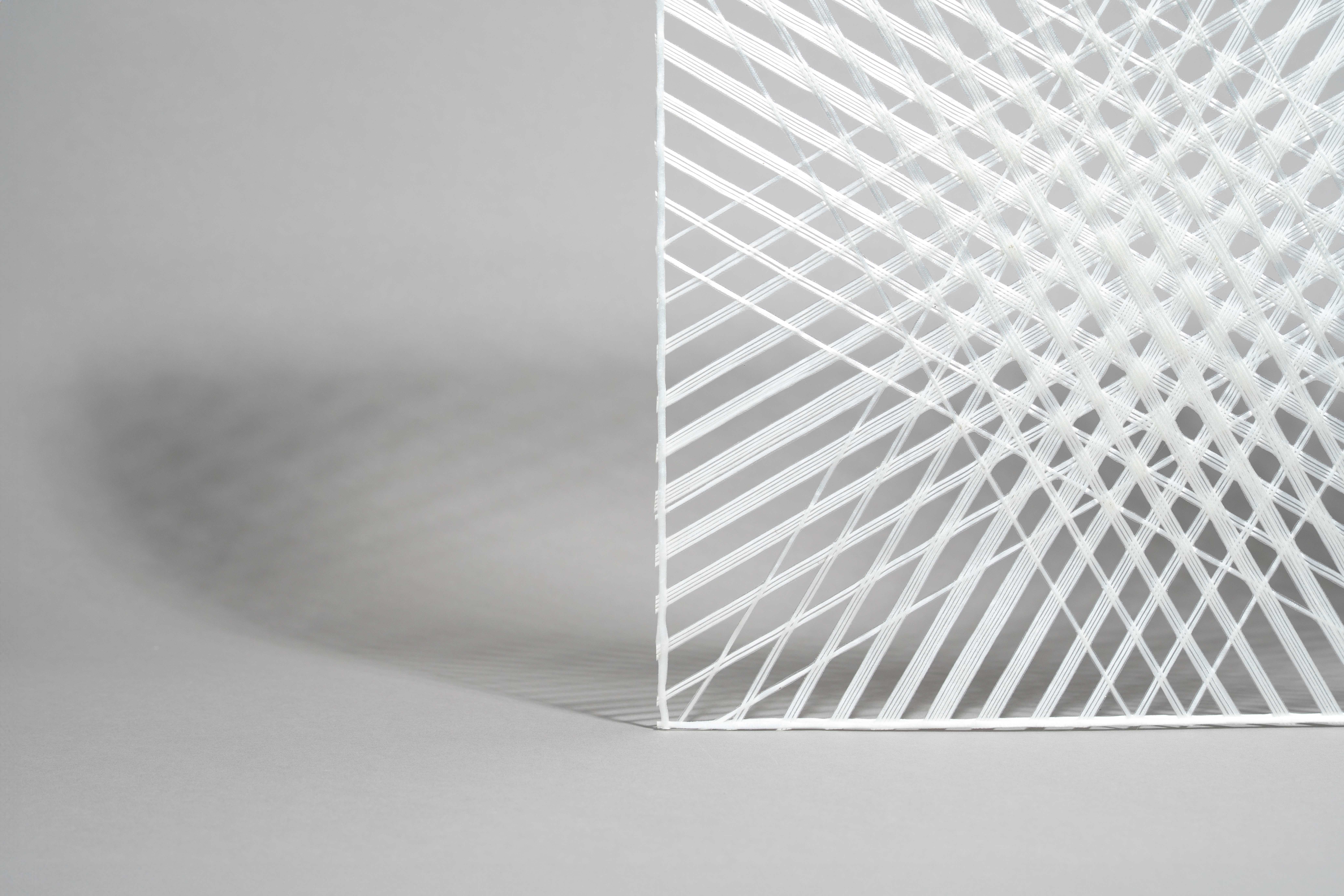 Close-up detail of the custom i-Mesh architectural textile pattern for HARADA Store — white fiberglass threads intersecting at multiple angles, showing mesh structure, layering depth and light diffusion