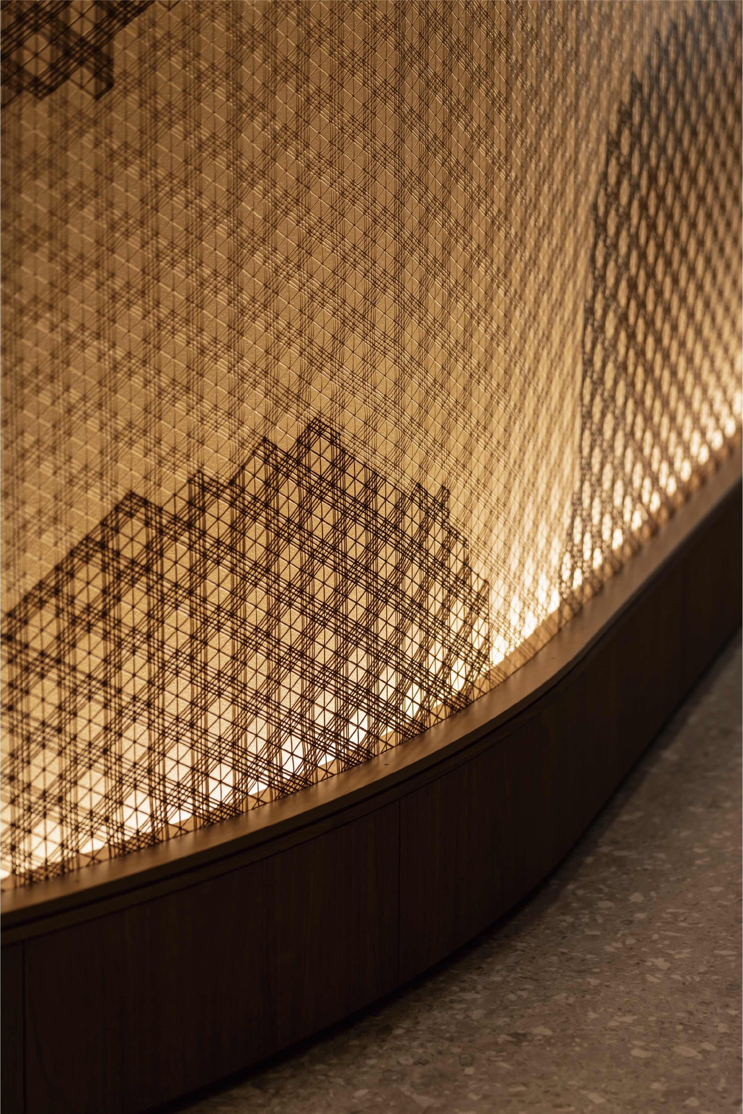 Close-up detail of i-Mesh surface showing the geometric Kumiko-inspired weave and backlighting effect