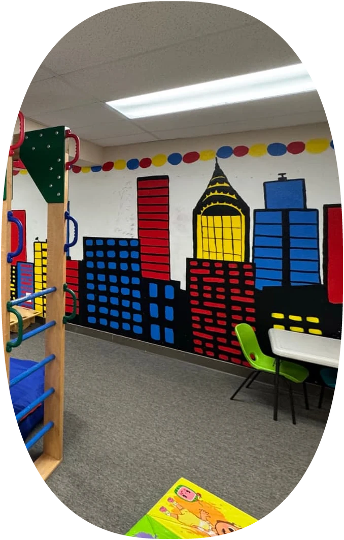 Attain SLB sensory gym with a painted city mural and climbing ladder in Fort Collins