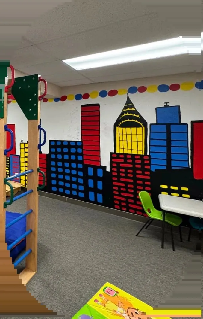 Attain SLB sensory gym with a painted city mural and climbing ladder in Fort Collins