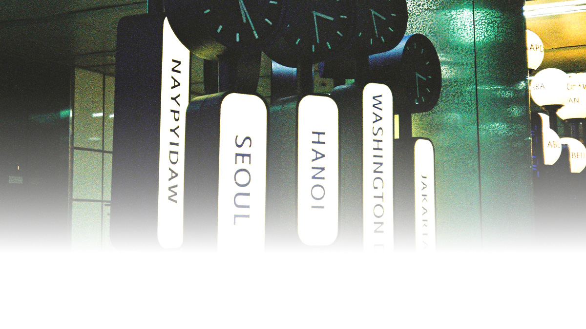 Airport-style world clocks showing global time zones across major cities, including Jakarta, Washington D.C., Hanoi, Seoul, and Naypyidaw.