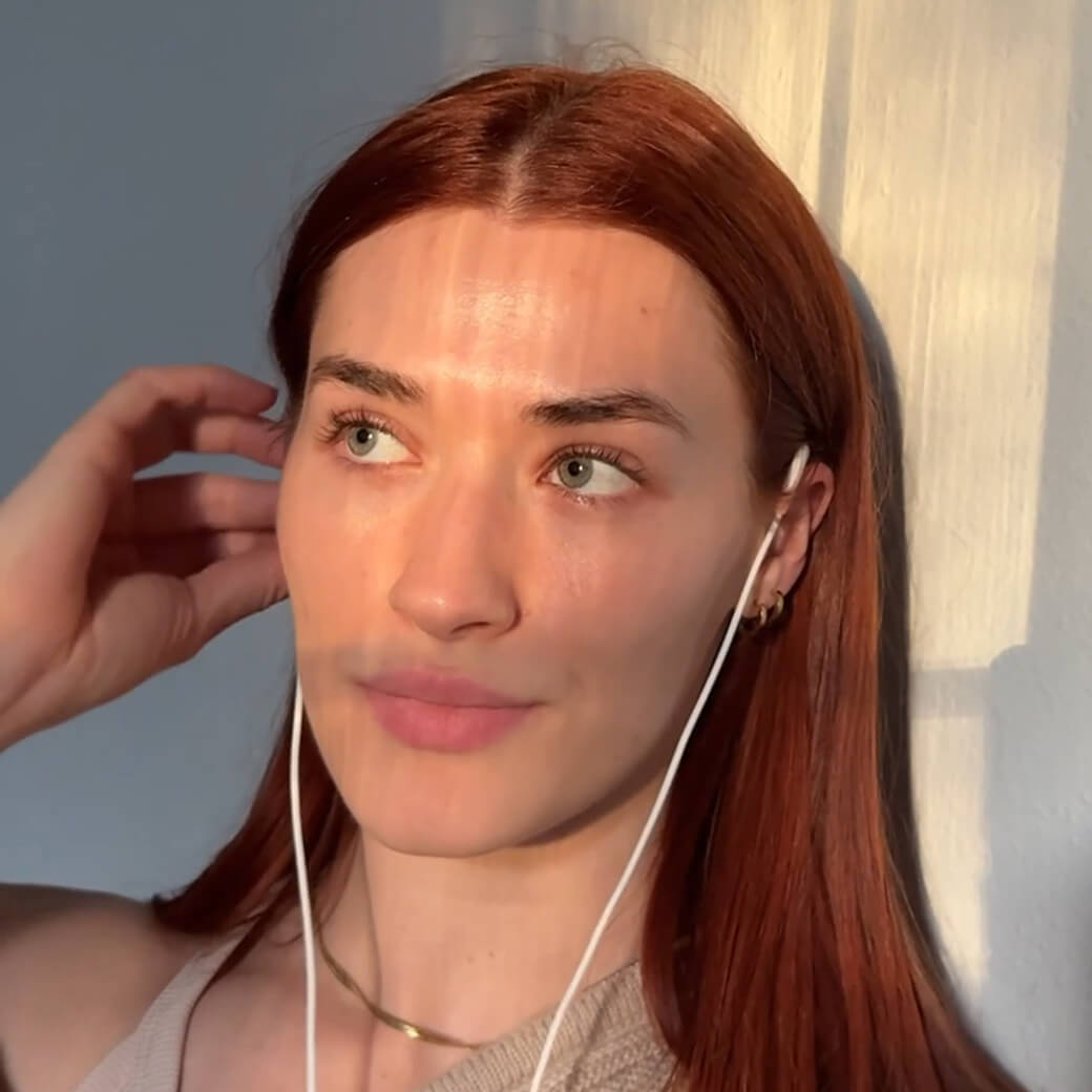 A woman with red hair wearing the Roga device.