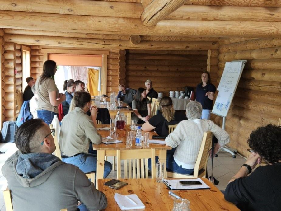 A group of people sitting around a table in a log cabinAI-generated content may be incorrect.