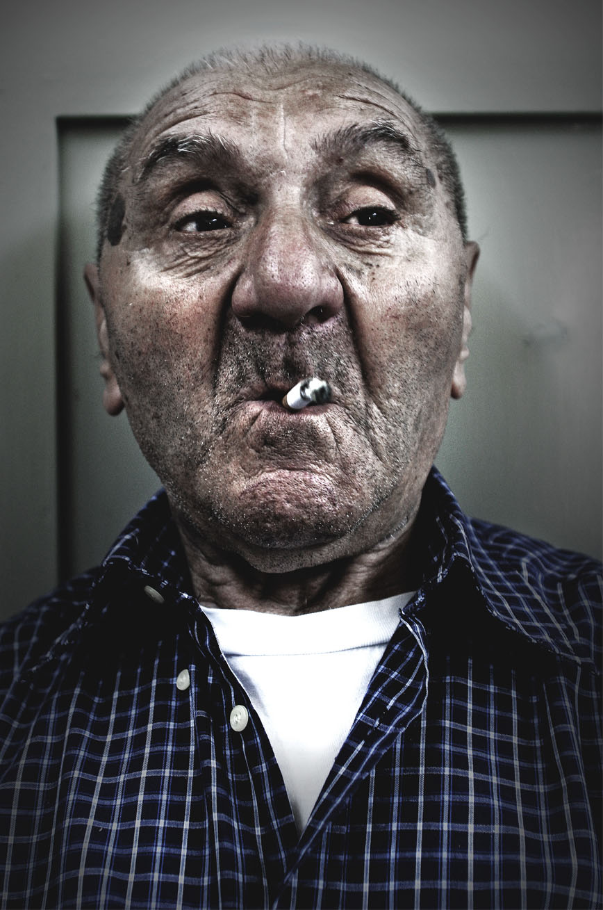 Tony Hassler, weathered man with cigarette, intense close-up portrait