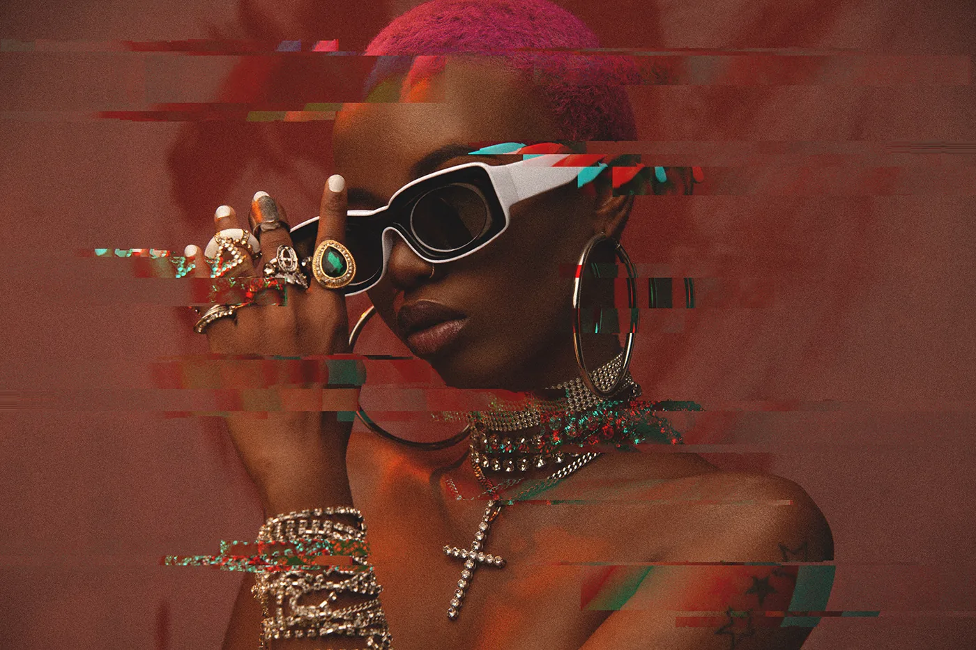 A woman wearing sunglasses and a necklace.