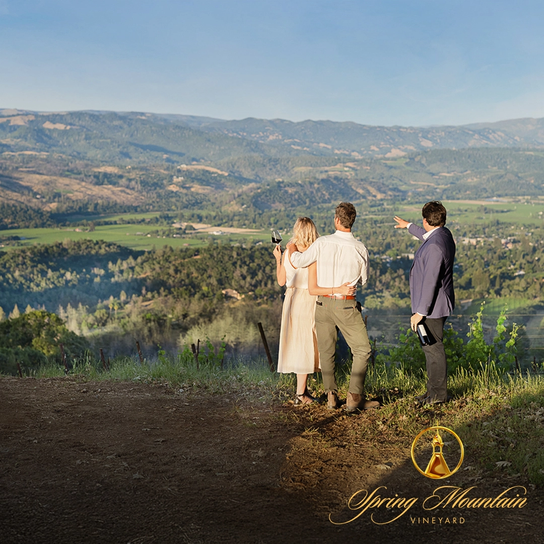 Two wine tasting guests and their guide taking in the exceptional Napa Valley views from the Spring Mountain Vineyard vista.