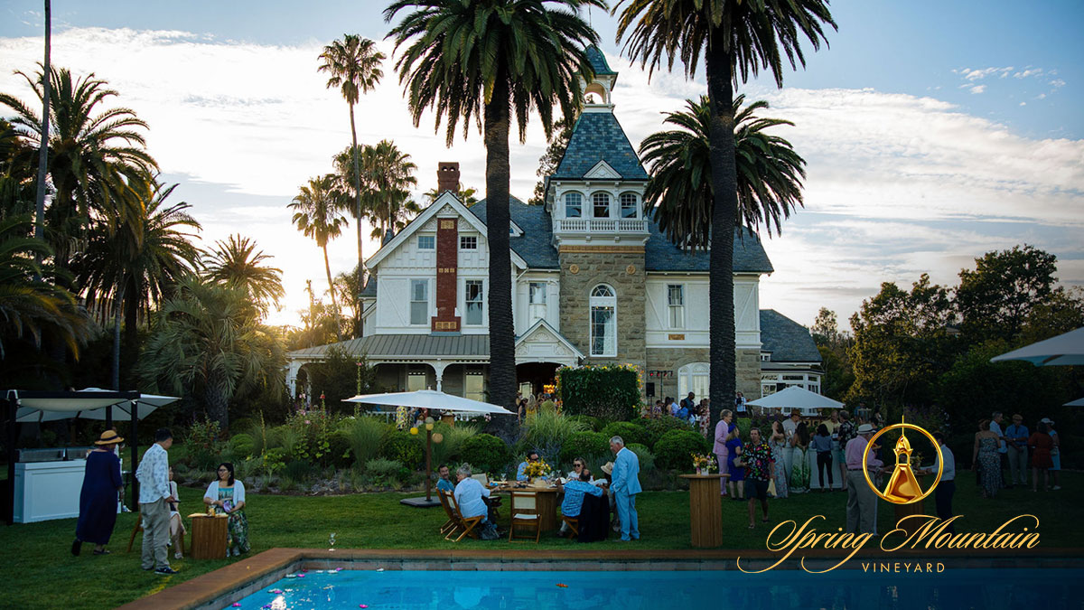Guests gathered on the lawn of the historic Spring Mountain Vineyard estate during an outdoor event.