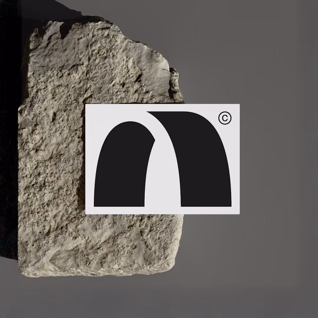 Studio Arch Business Card sat on a concrete rock.