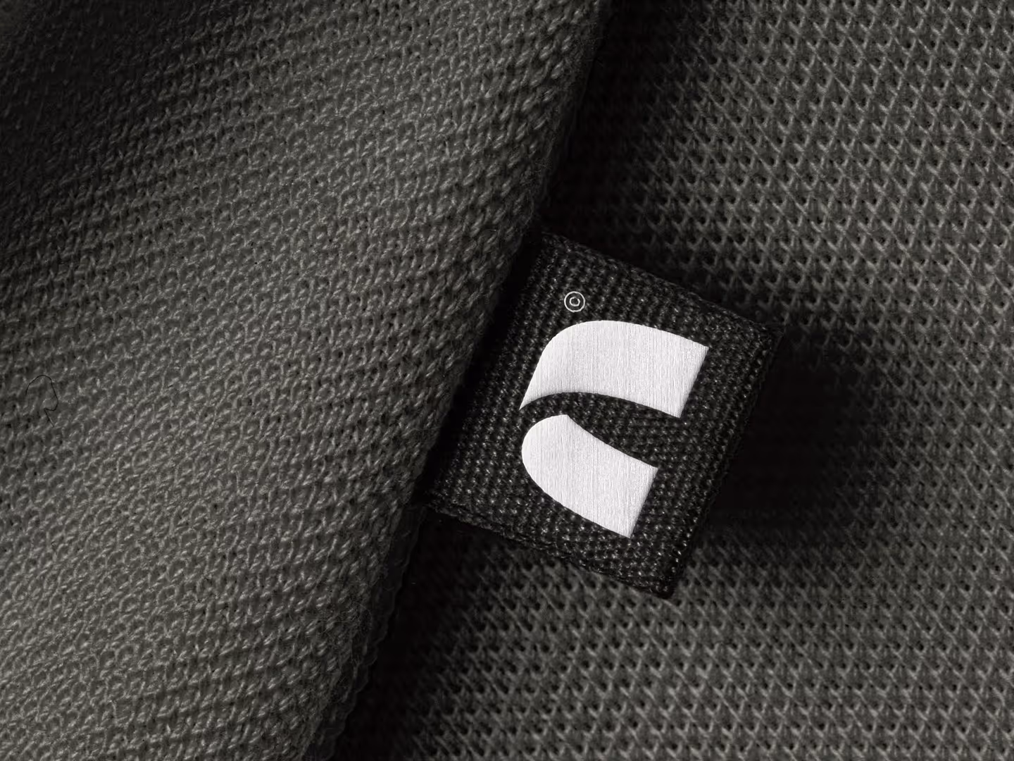 Studio Arch Icon Embroidered onto Clothing Label.