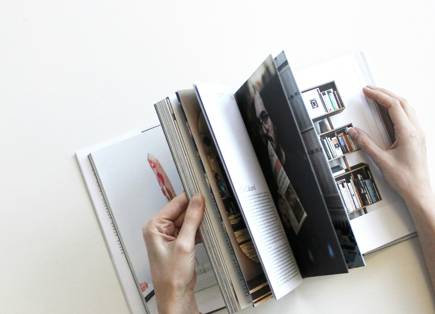 Hands paging through a book with images | Kelly Agency Images