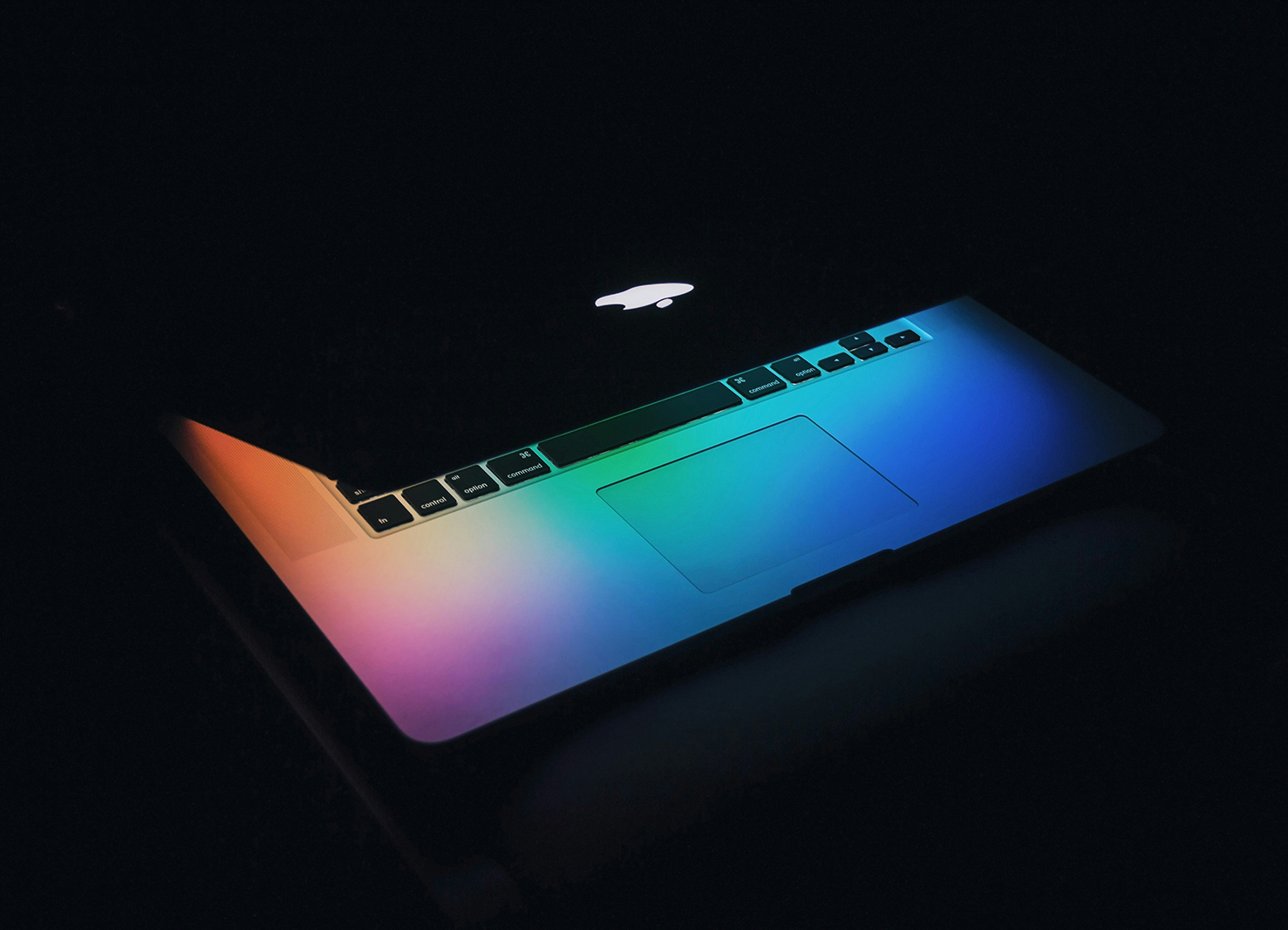 A half closed laptop with its light shining | Kelly Agency Images