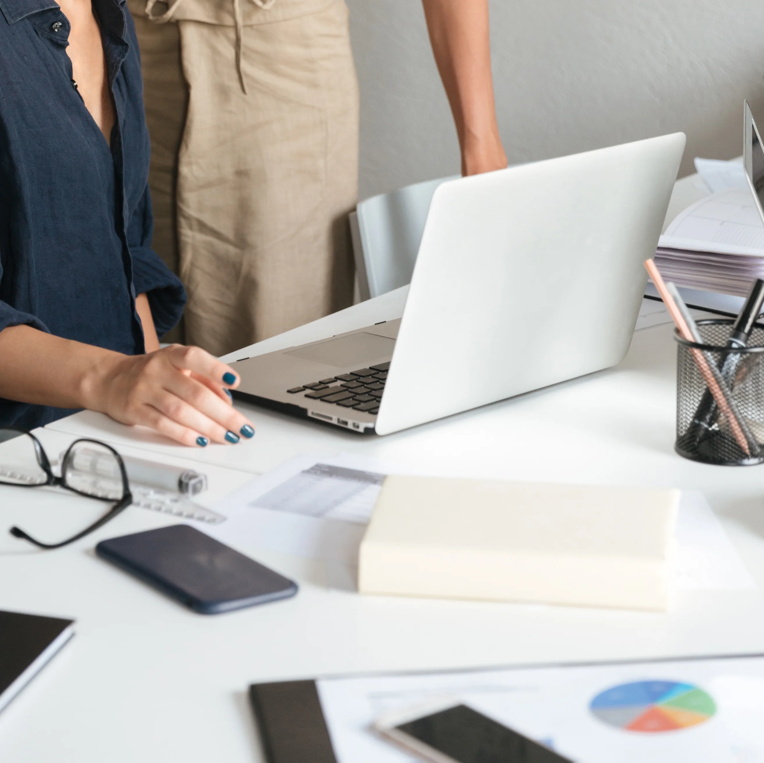 A messy desk with a laptop and papers | Kelly Agency Images