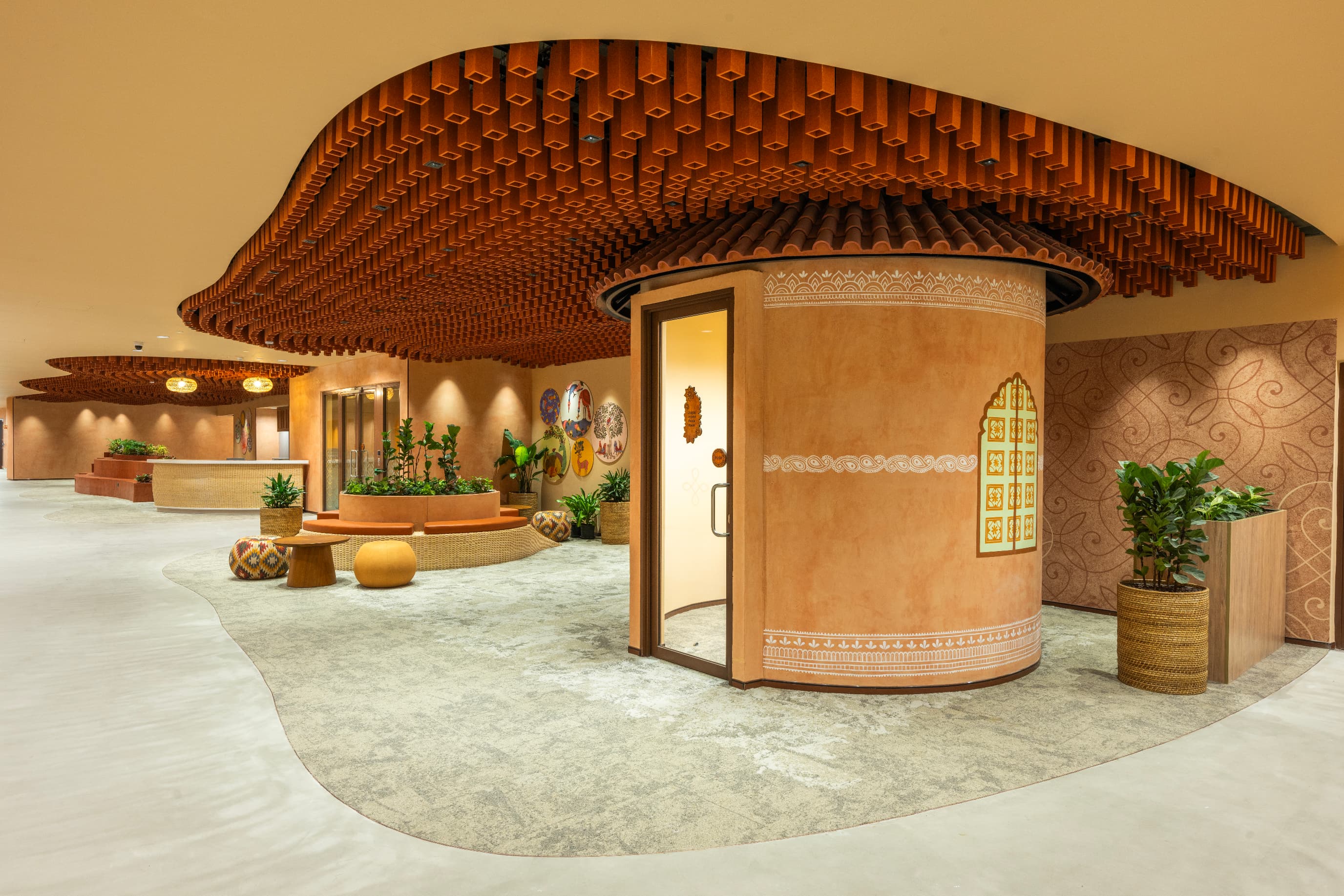 Nearly every element was crafted on site. Hand-painted borders, rangoli-inspired patterning and curated folk artworks were executed by local artisans as the space was built around them.