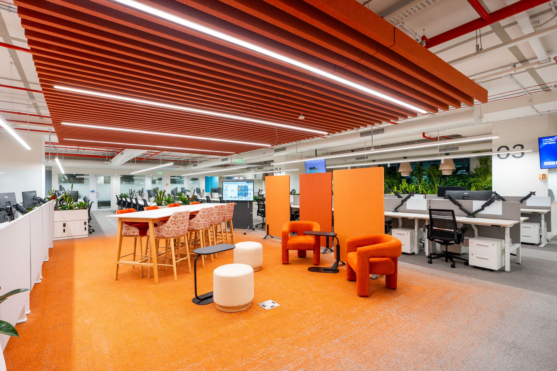 Agile seating and mobile acoustic screens sit directly among the workstations. Neighbourhoods are numbered so employees can navigate straight to a seat booked from the screen at reception.