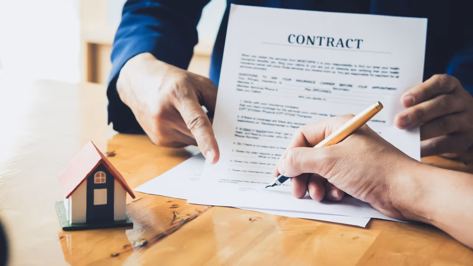 A person signing a contractAI-generated content may be incorrect.