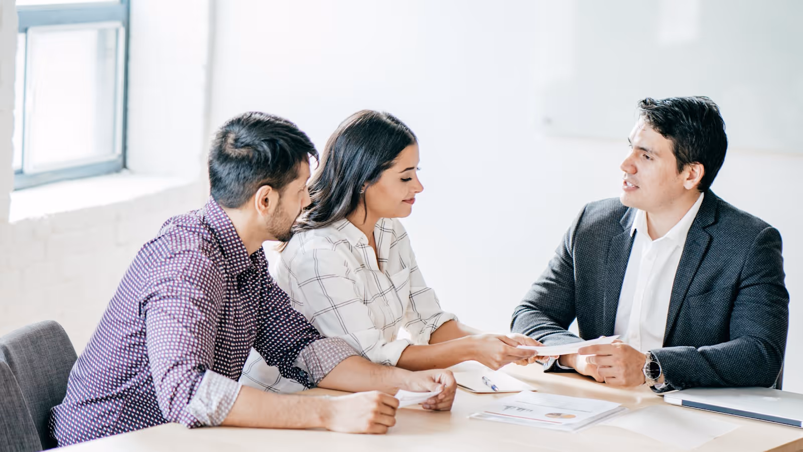A group of people sitting at a tableAI-generated content may be incorrect.