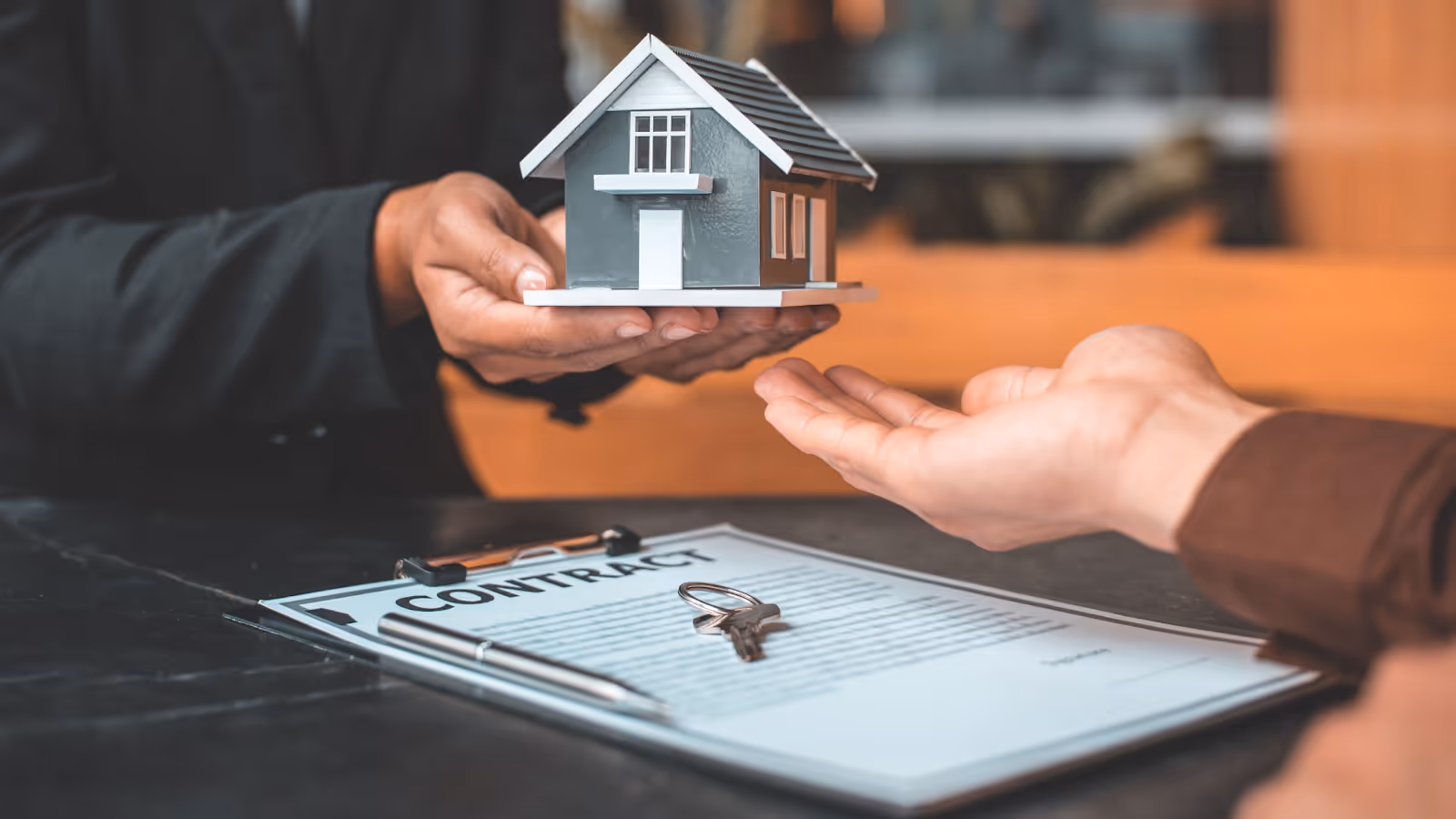 A person handing over a houseAI-generated content may be incorrect.