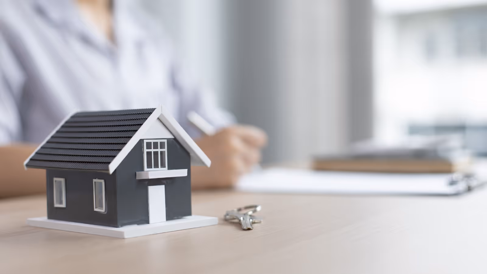 A small model of a house on a tableAI-generated content may be incorrect.