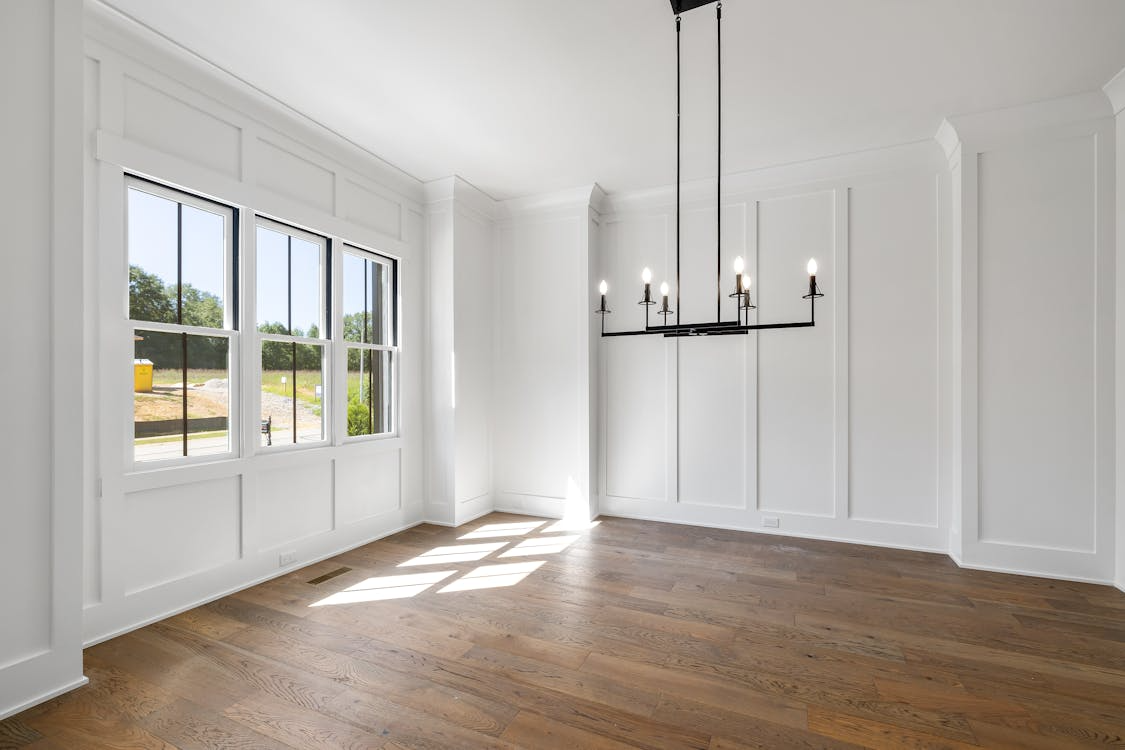 A room with a chandelier and windowsAI-generated content may be incorrect.