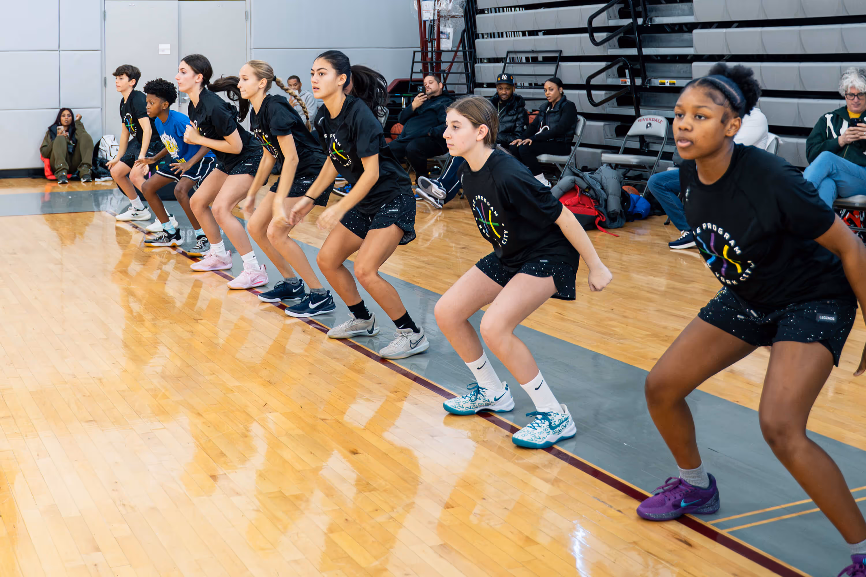 Group of high-school girls practicing basketball skills and drills at The Program NYC camp at Riverdale school