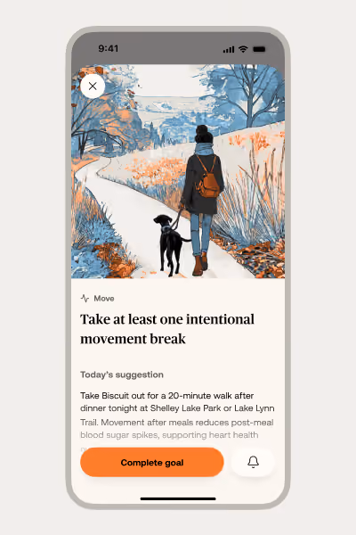 Smartphone screen showing a wellness app recommending a 20-minute walk with a person walking a dog on a leaf-strewn path.