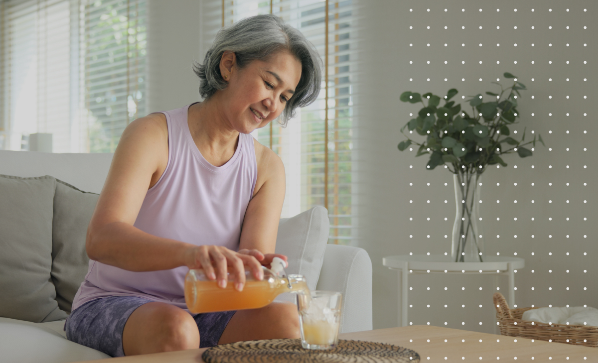 woman pouring a glass of juice