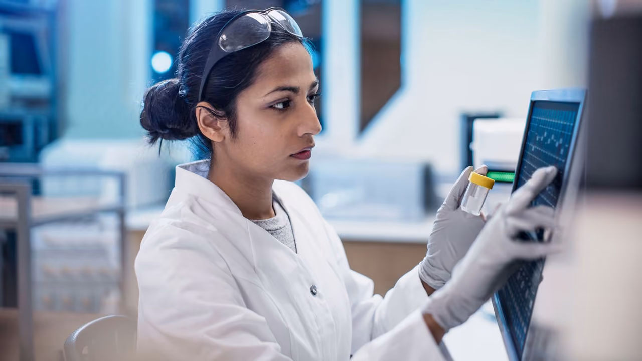 Female medical technician in a laboratory examining tests.
