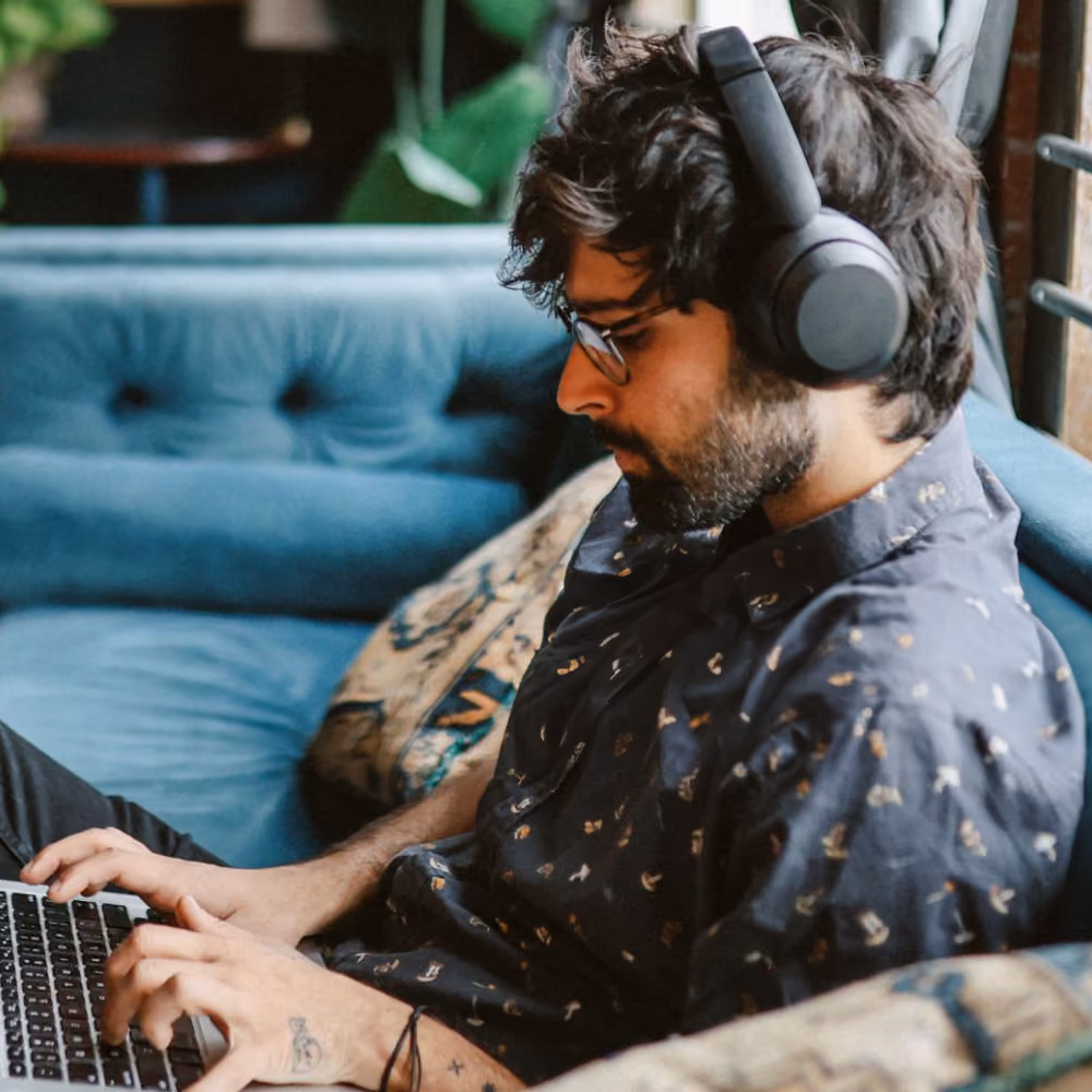 A man in a cafe working on his laptop.