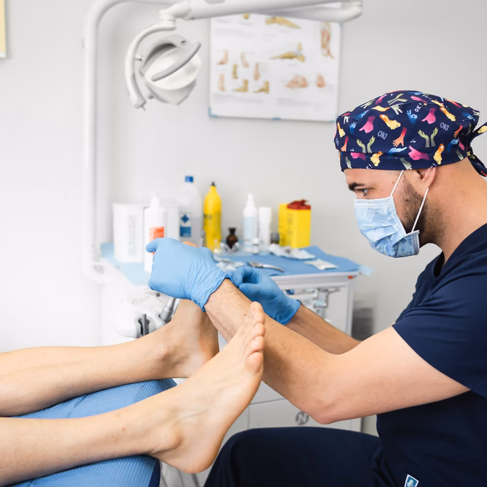 A patient at the podologist's office, the doctor is carefully doing his work.