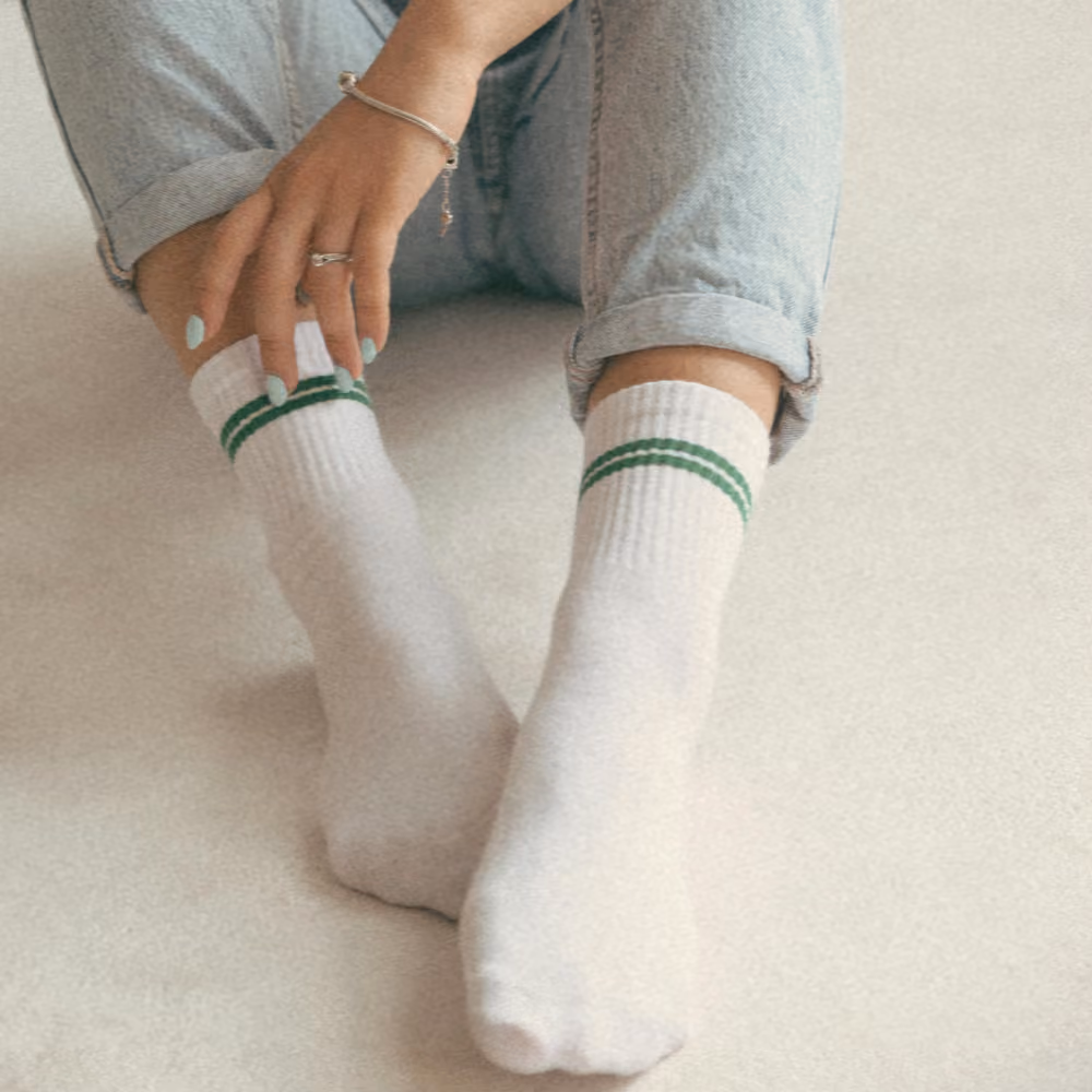 Morning photo of woman's feet on bed.