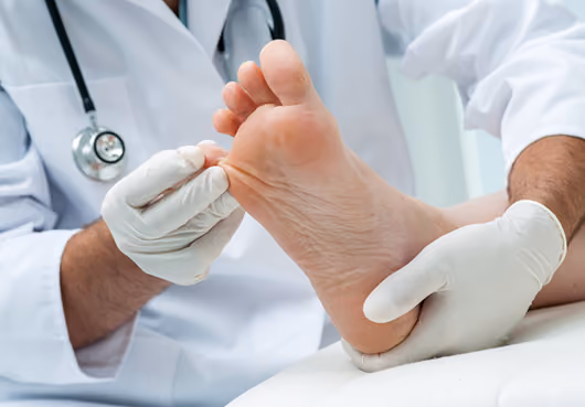 A doctor scrutinizes a patient's foot.
