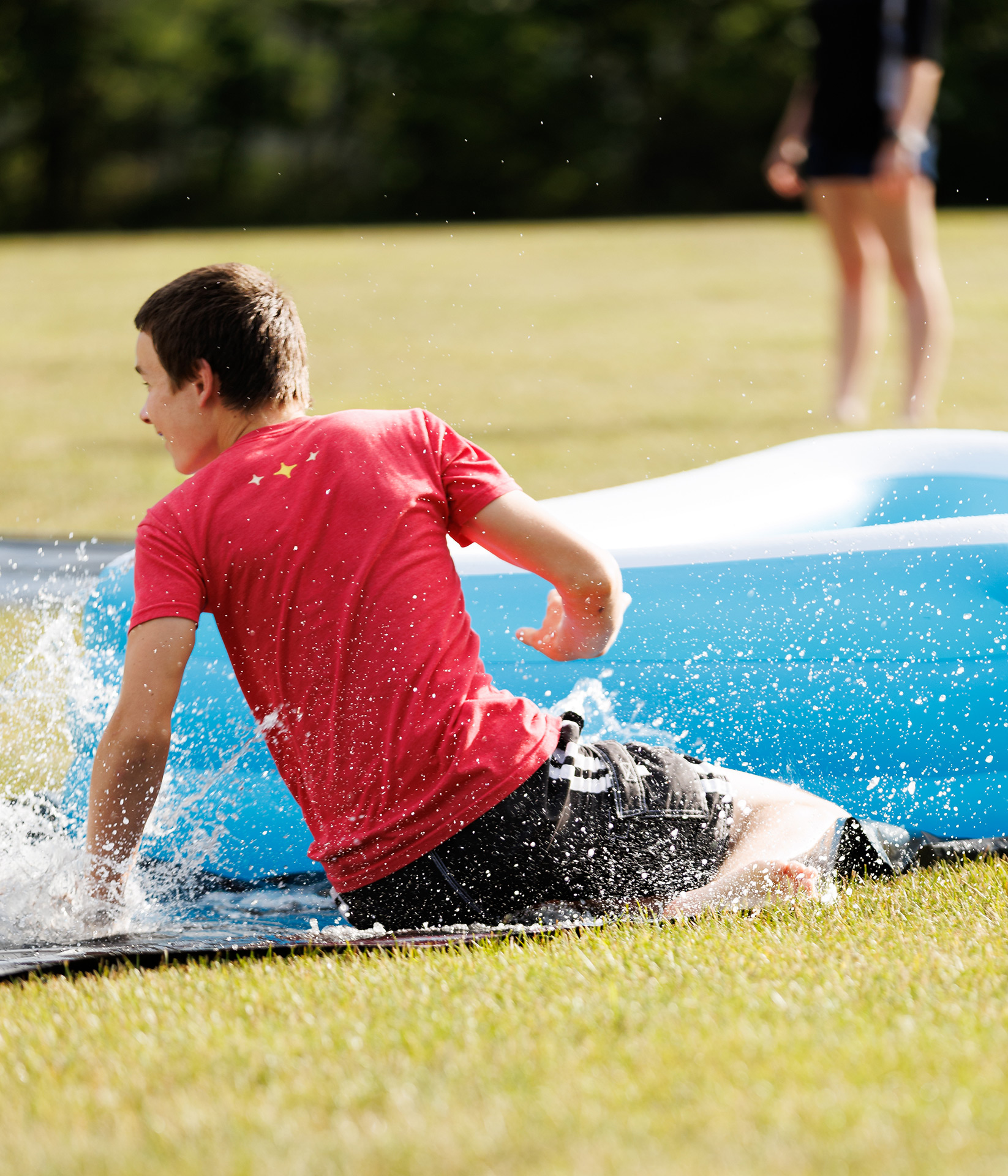 teen sliding during kickball