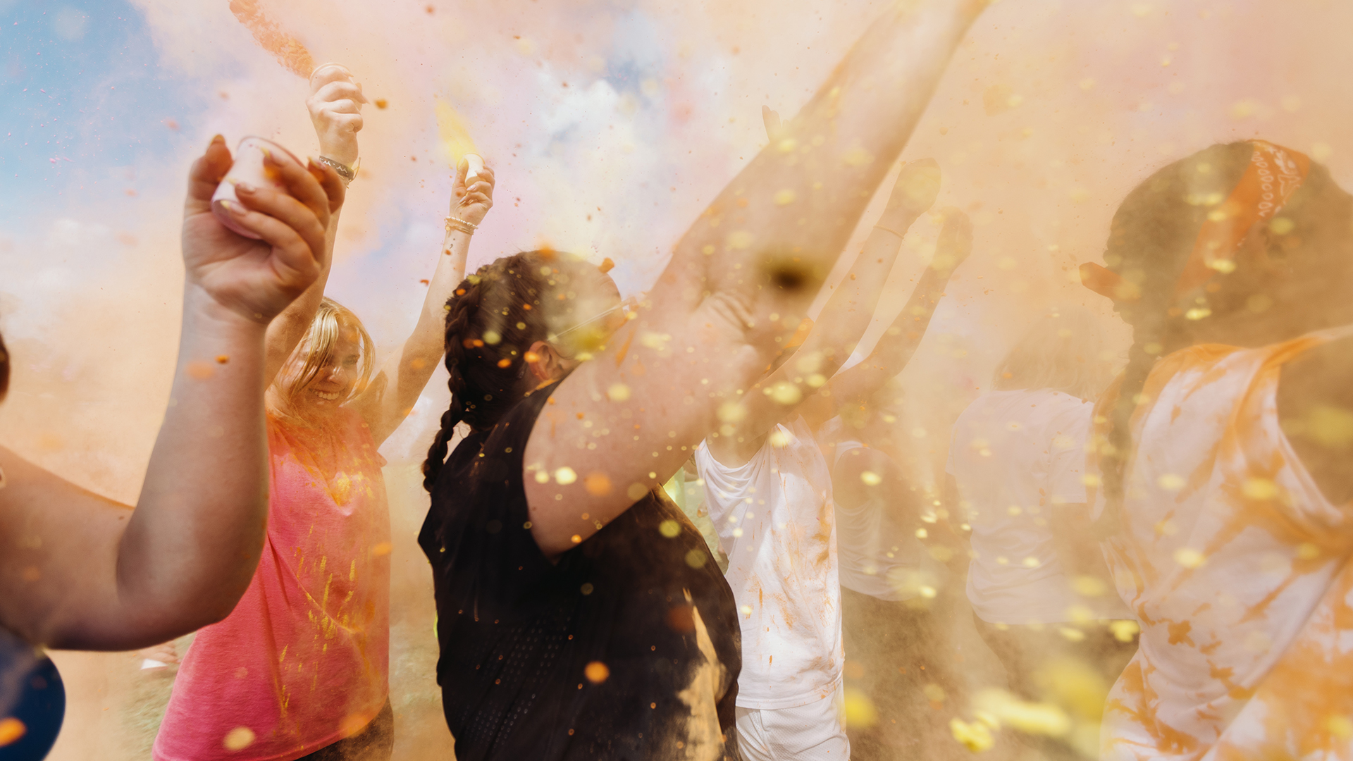 students throwing colored powder