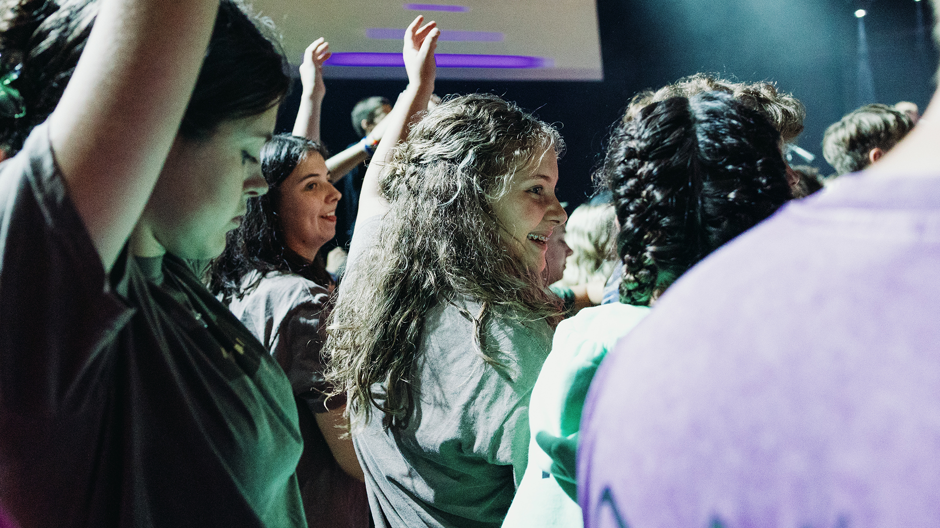 student smiling during worship
