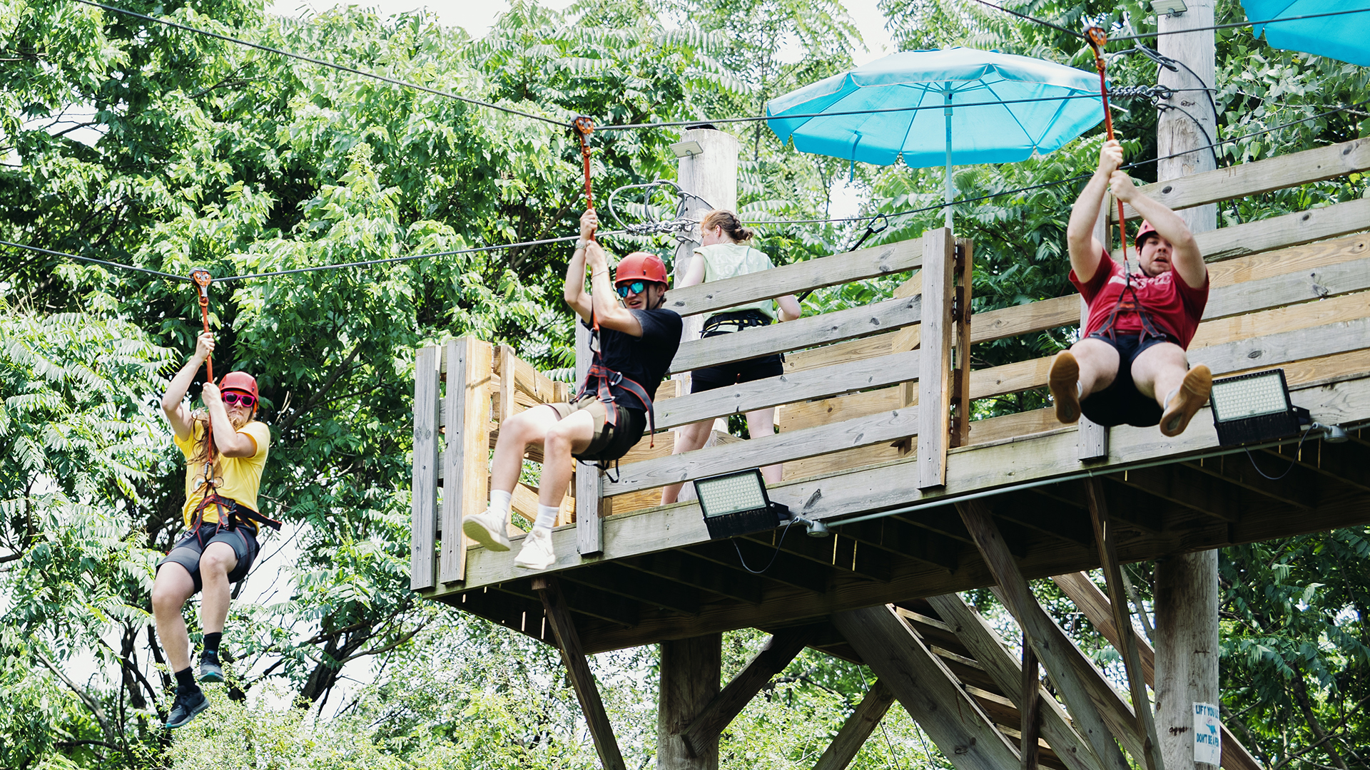 three students on the zipline