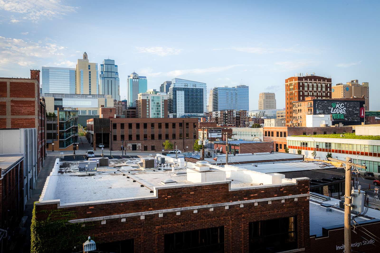 A city skyline with a clock tower and a large building with a clock on the side.
