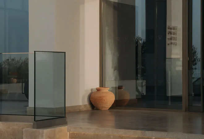 Terracotta pottery vase near glass window in minimalist interior setting