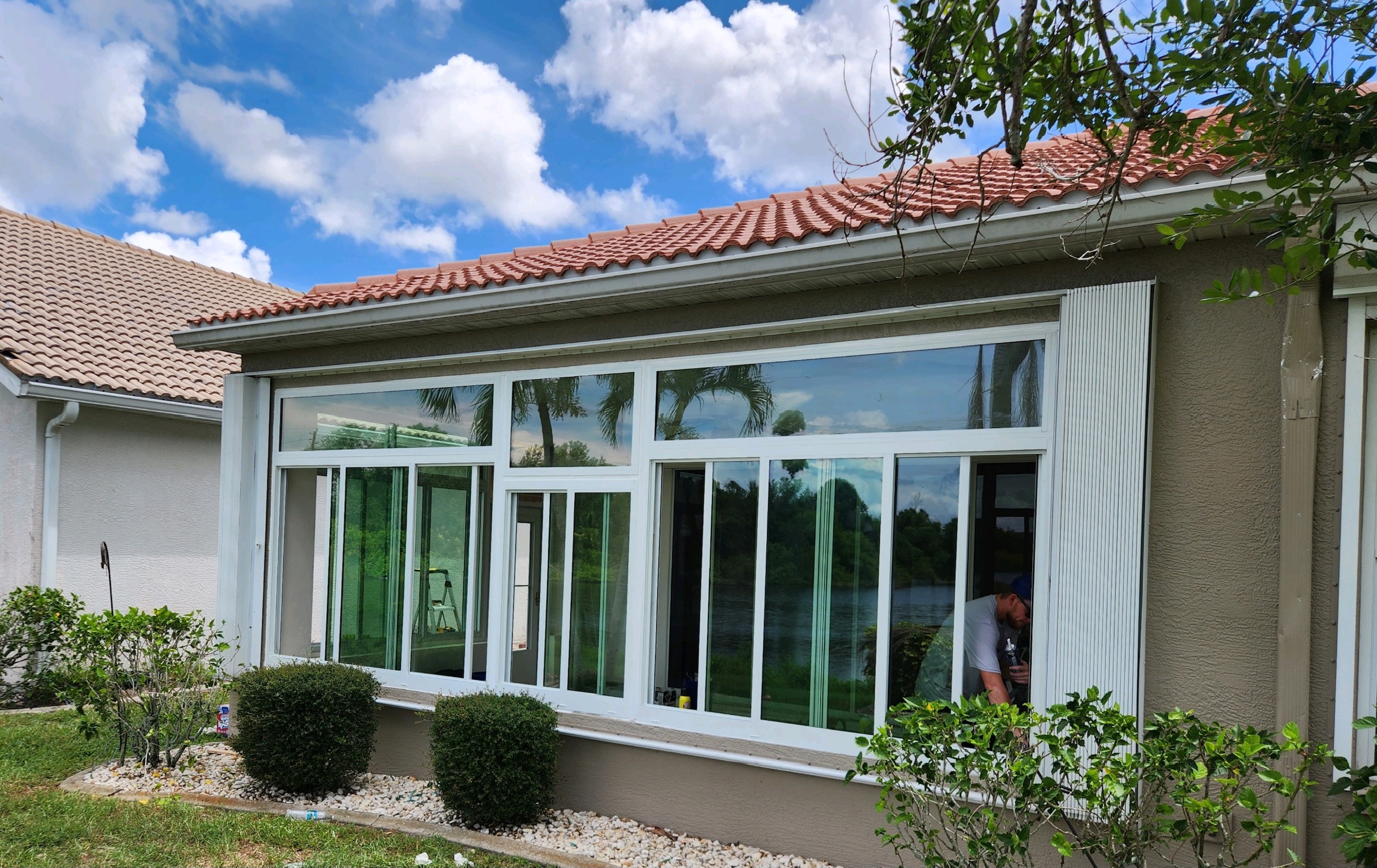 Hurricane-resistant impact windows installed on Florida home exterior