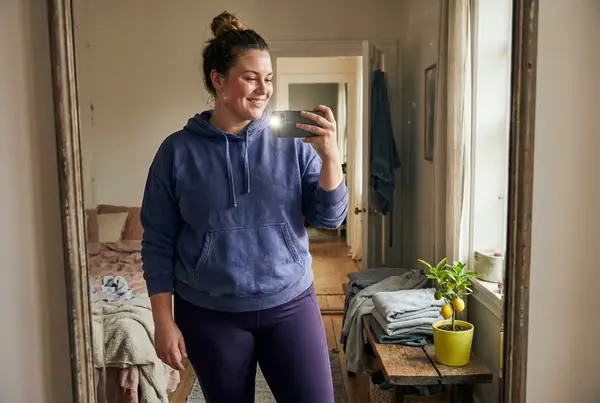 Woman taking a selfie at home — placeholder image for the Core Tab timeline section