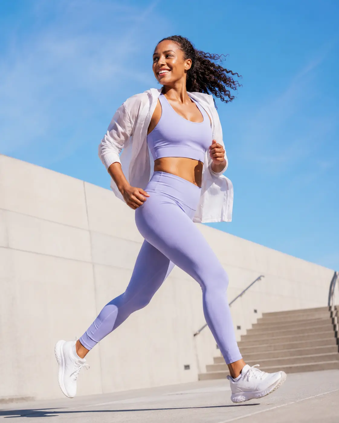 Woman in lilac activewear running outdoors — GobyMeds weight loss treatment for women