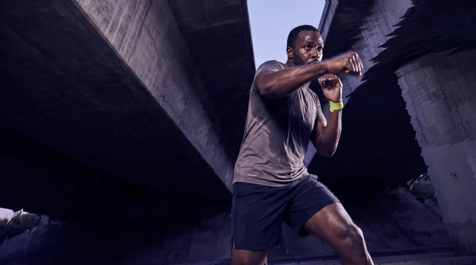 Man shadowboxing under a city overpass — GobyMeds weight loss treatment for men