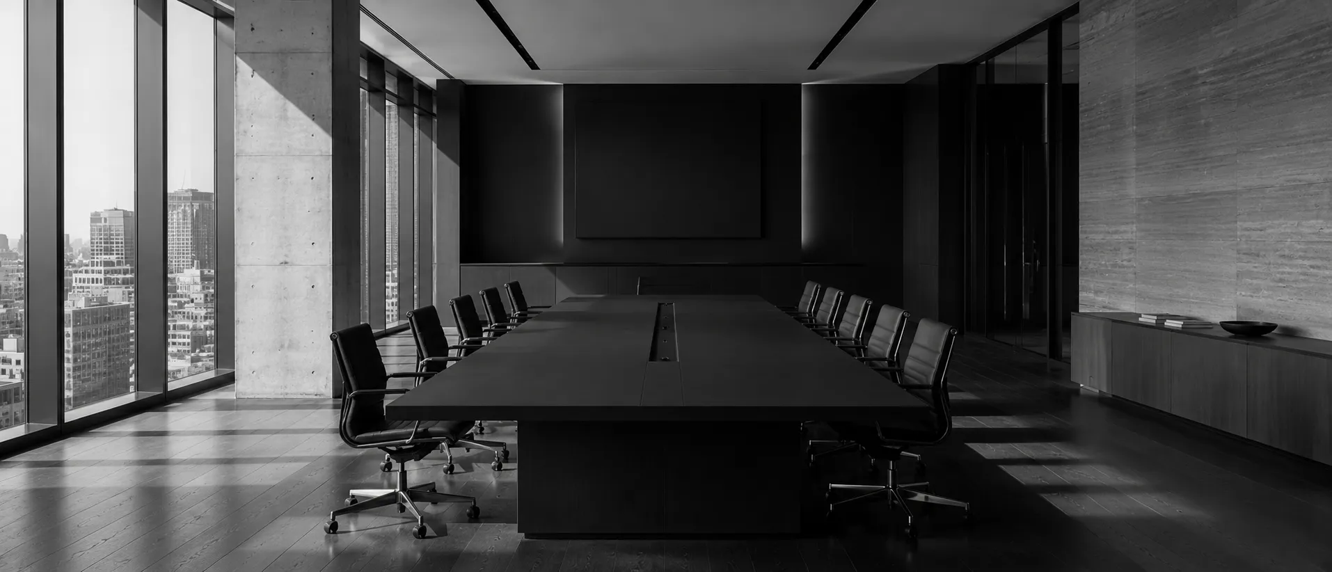 Modern executive boardroom interior, empty, in monochrome.