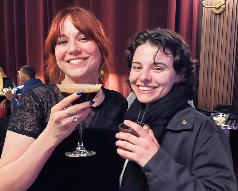 A picture of Marissa and her friend holding drinks.