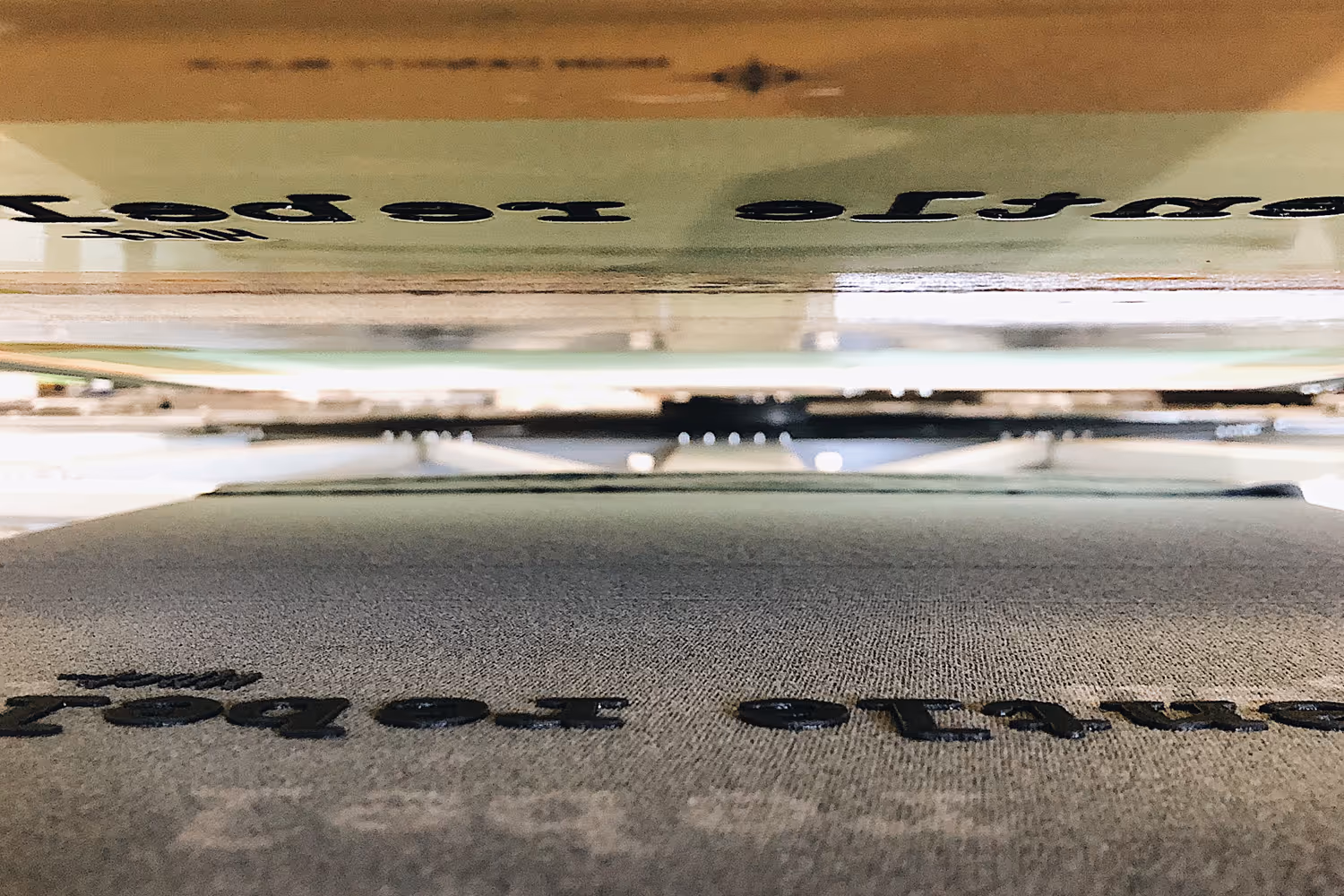 An image of the back of a screen and layers of high density ink  on a shirt.