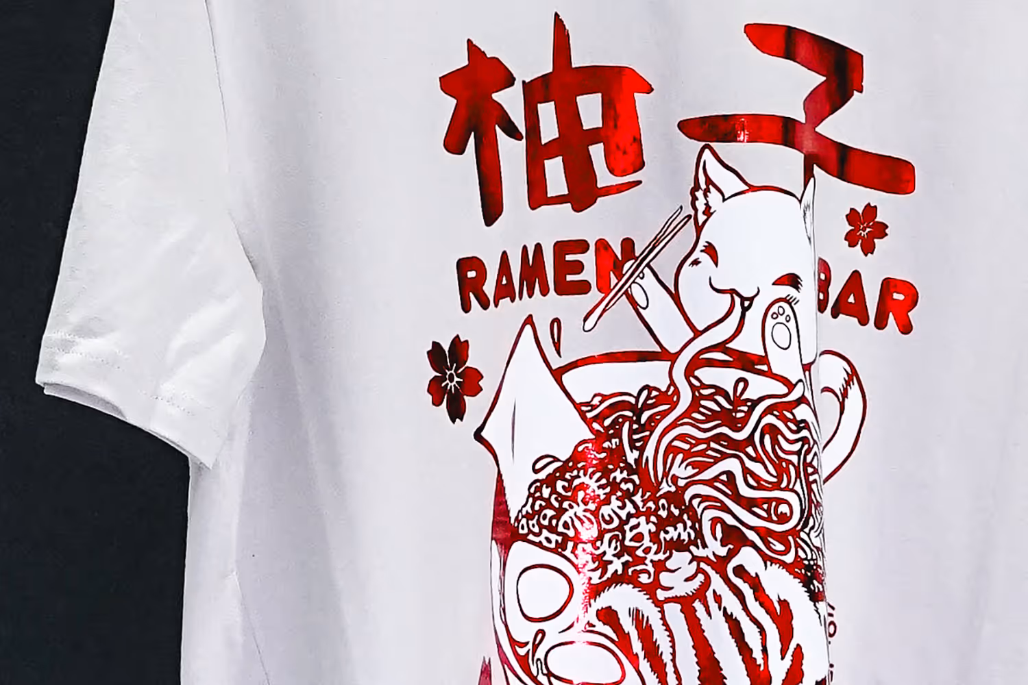 An image of a foil print featuring a cat eating a bowl of ramen.