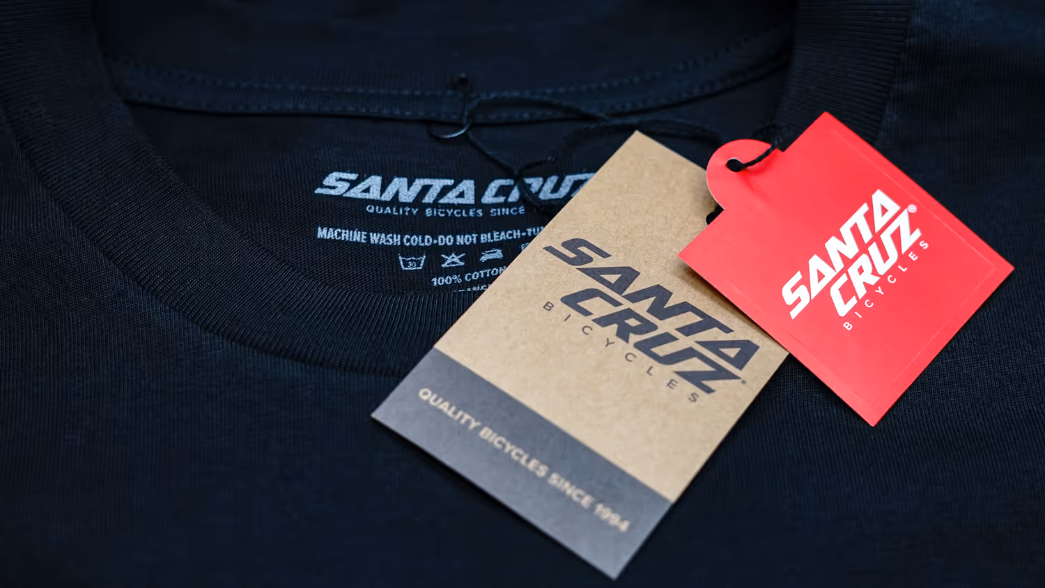 A hangtag, sticker and neck label combo applied to a garment for Santa Cruz Bicycles.