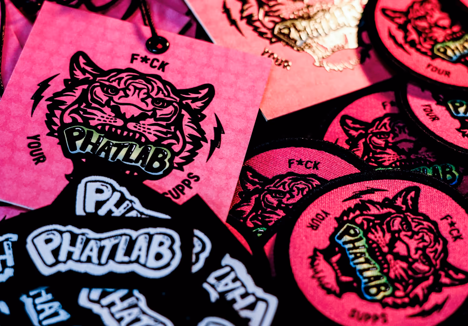 A pile of hang tags, woven labels and patches.