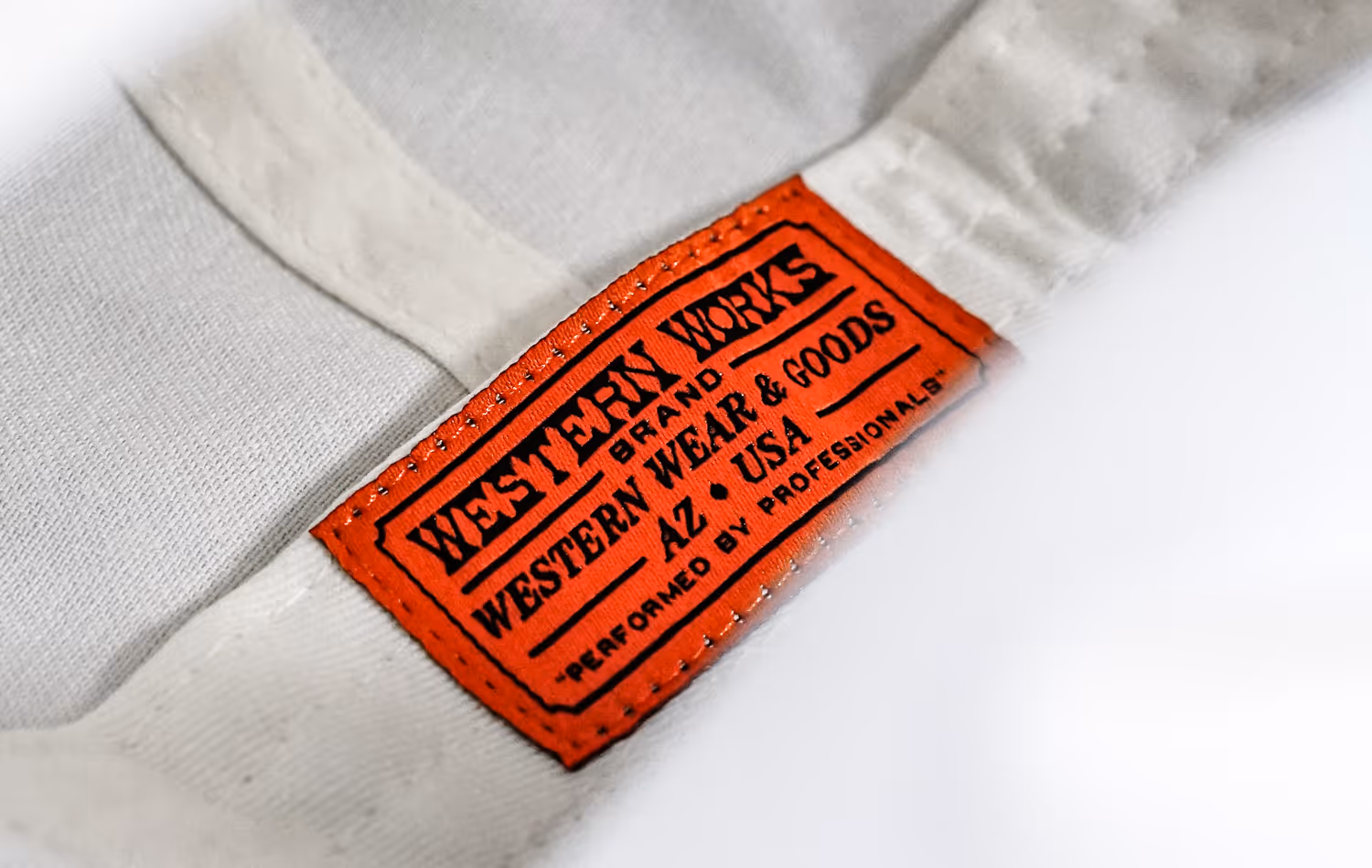 Label application on a hat for the brand Western Works.