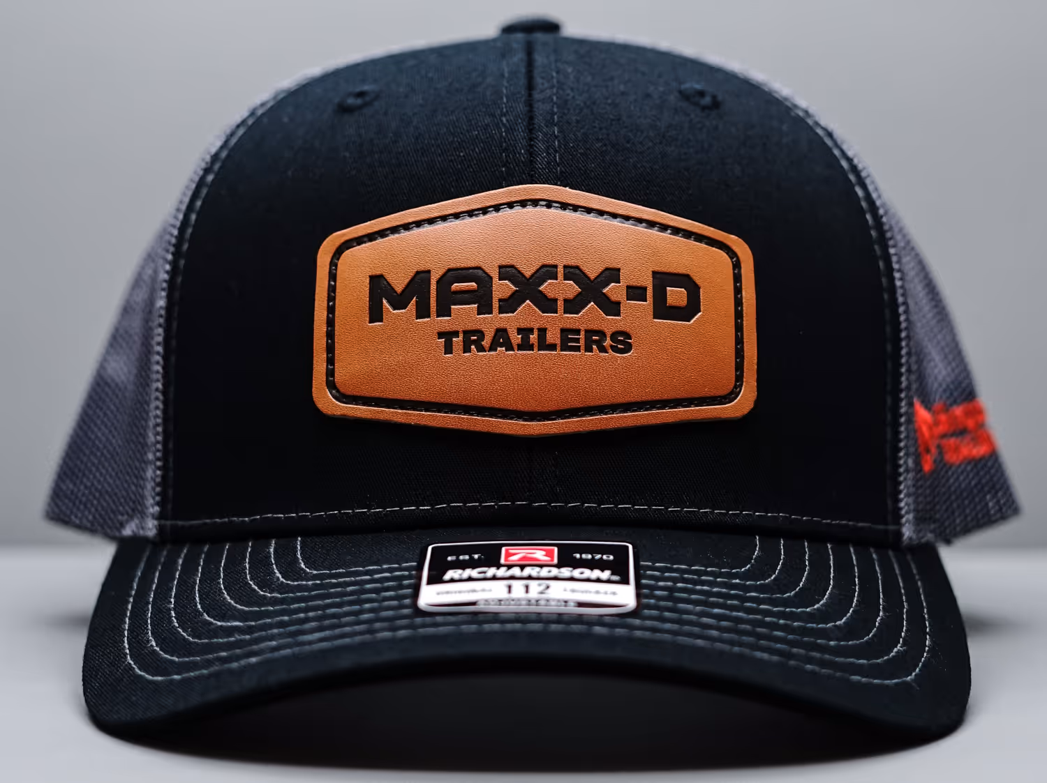 An image of a leather patch with the logo Maxx-D Trailers applied to a hat.