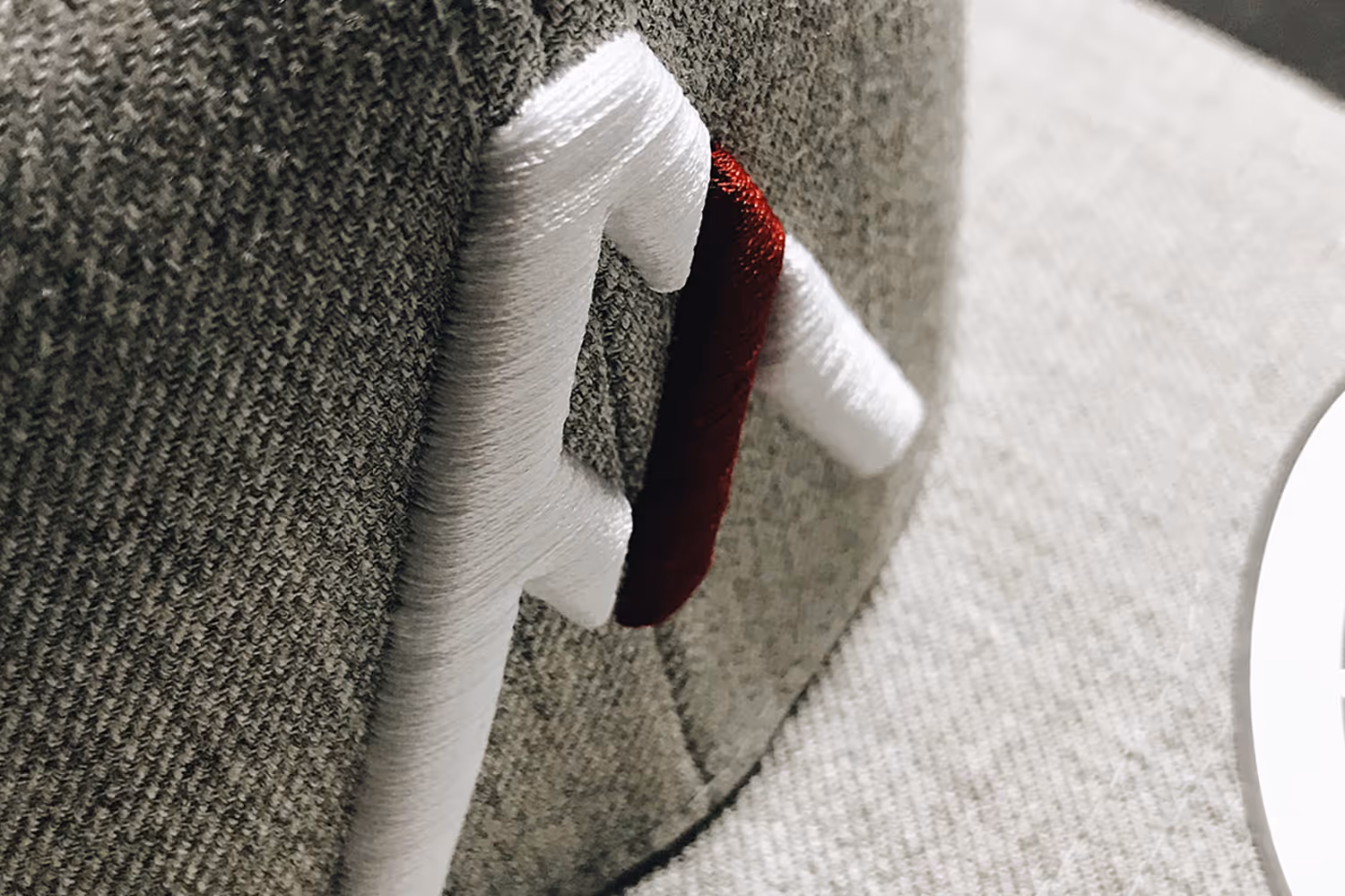 A close up image of 3D foam embroidery featuring the Alpha Male MMA logo.